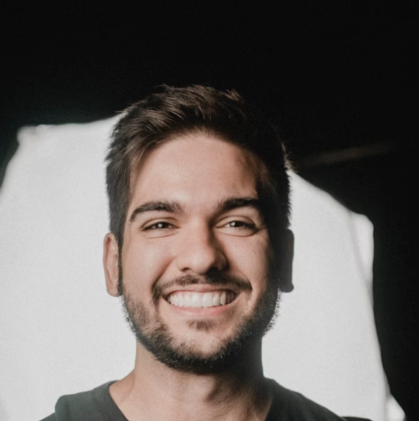 Young man smiling, dark background